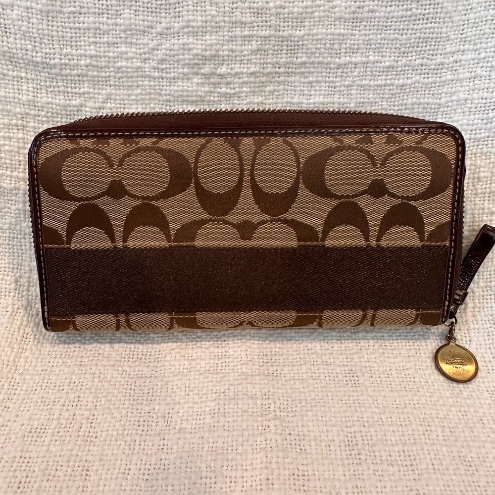 Lightly used vintage Coach Wallet with check book pockets with card slots.